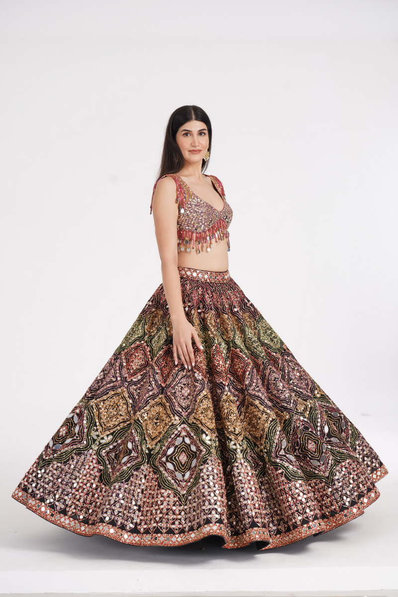 Matte black lehenga embellished using warm pastels