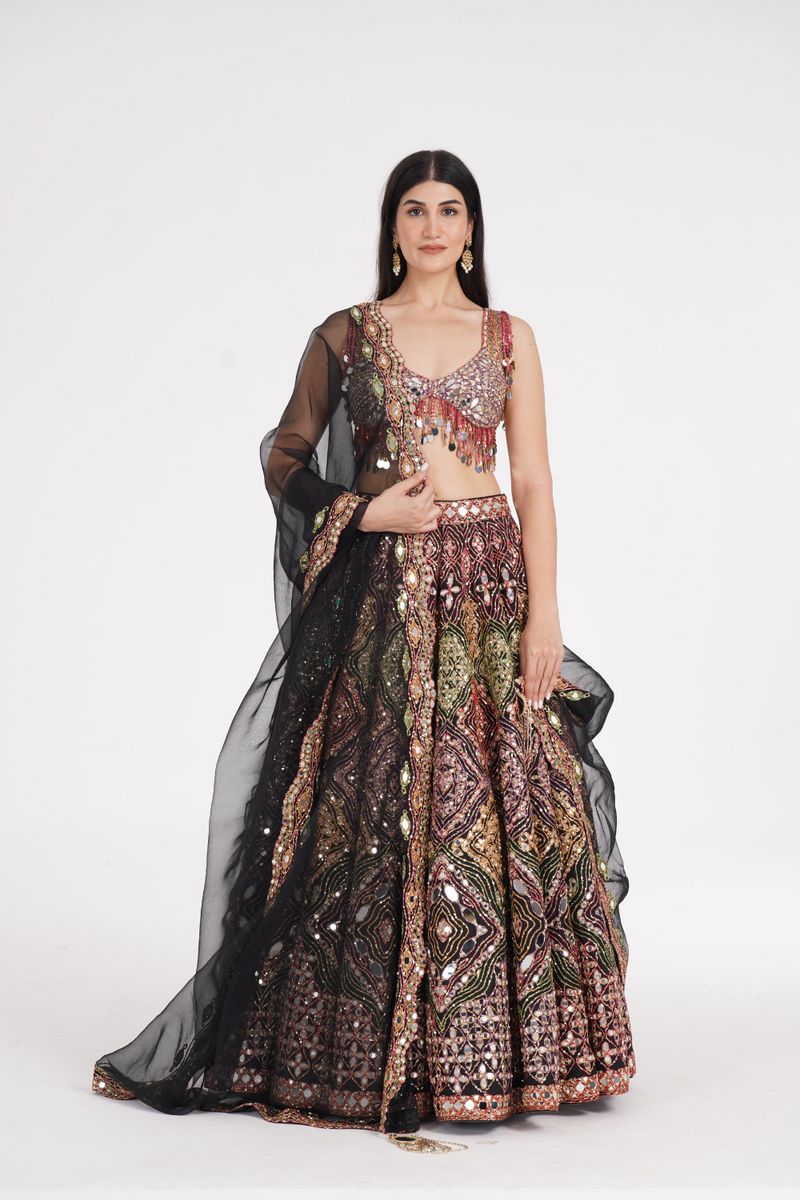 Matte black lehenga embellished using warm pastels