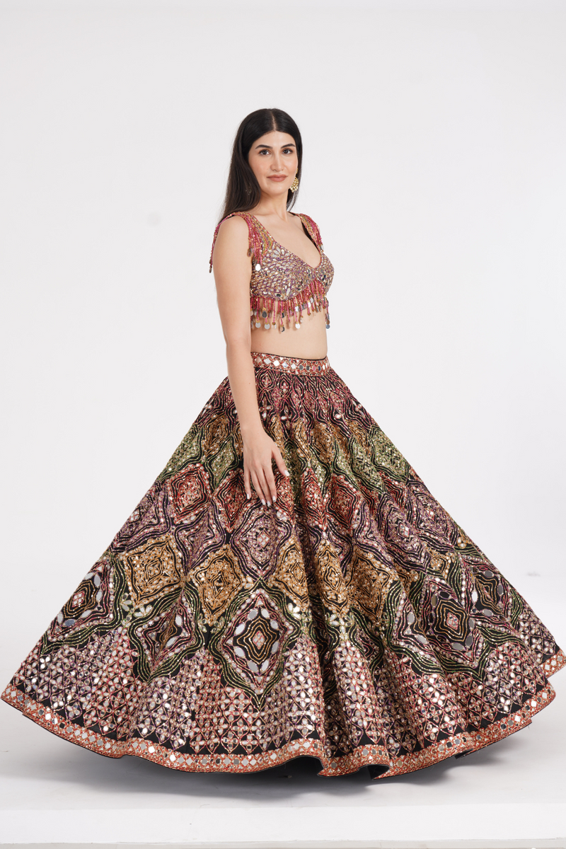 Matte black lehenga embellished using warm pastels