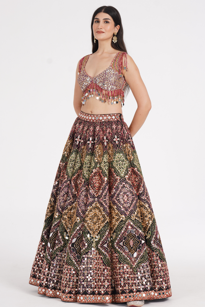 Matte black lehenga embellished using warm pastels