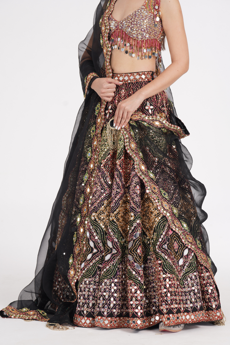 Matte black lehenga embellished using warm pastels