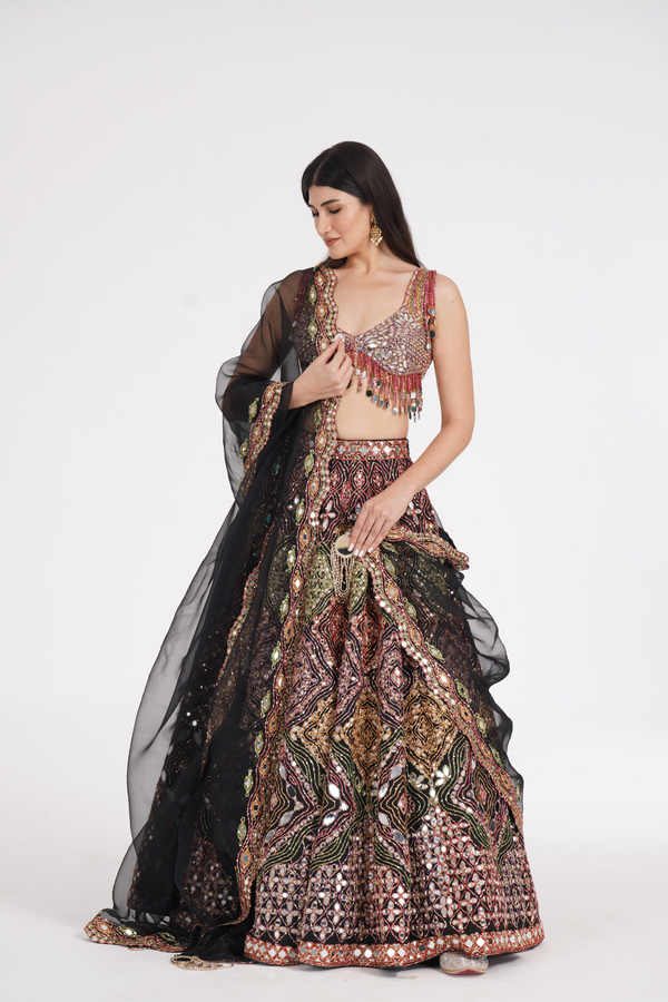 Matte black lehenga embellished using warm pastels