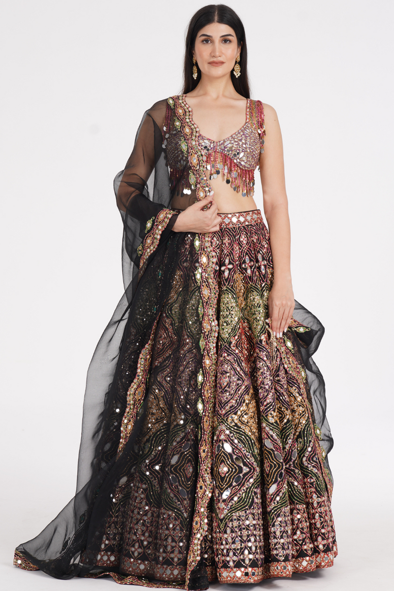 Matte black lehenga embellished using warm pastels