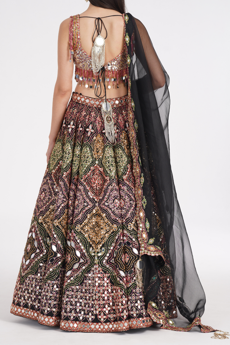 Matte black lehenga embellished using warm pastels