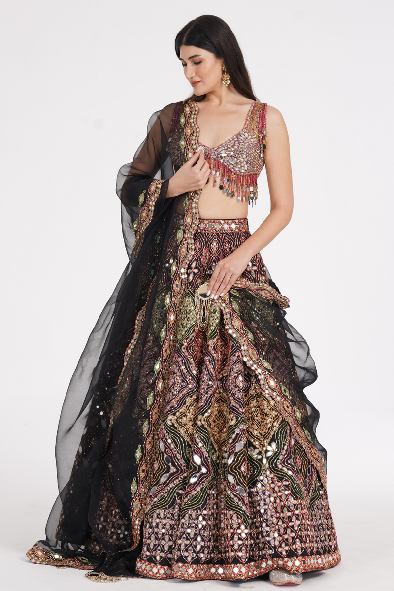 Matte black lehenga embellished using warm pastels