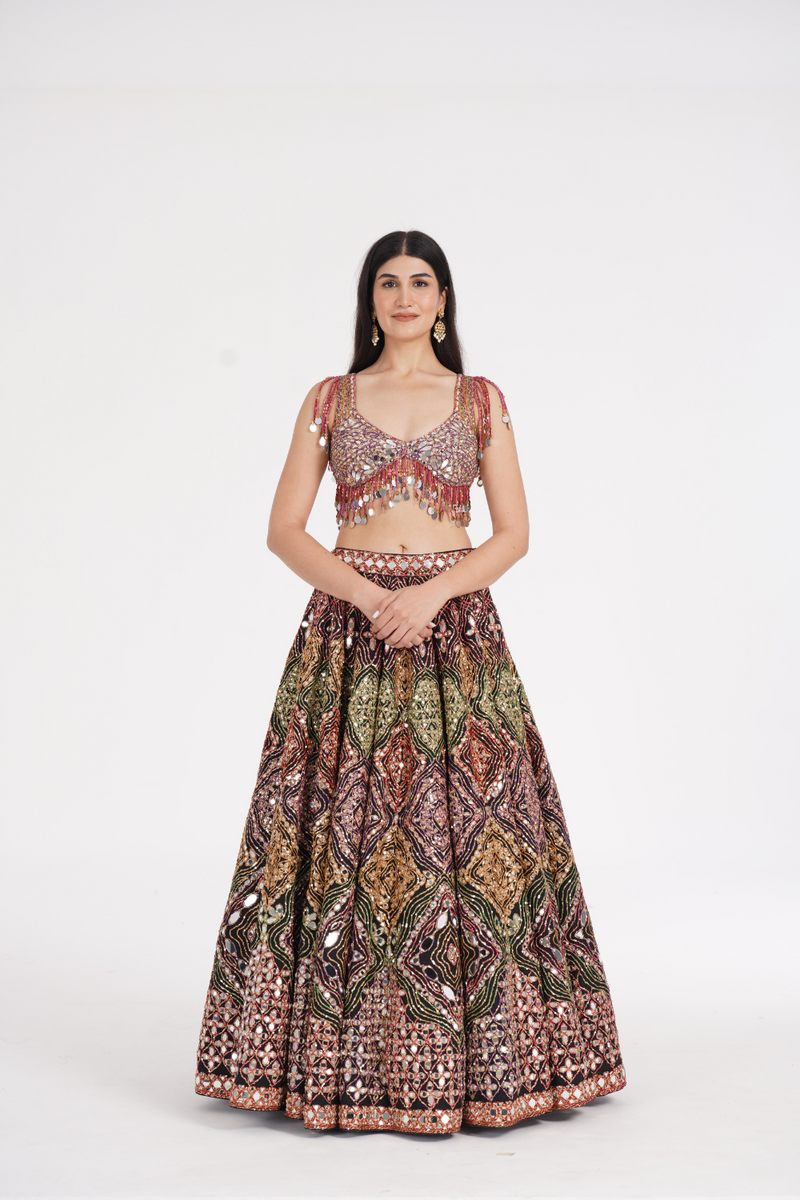 Matte black lehenga embellished using warm pastels