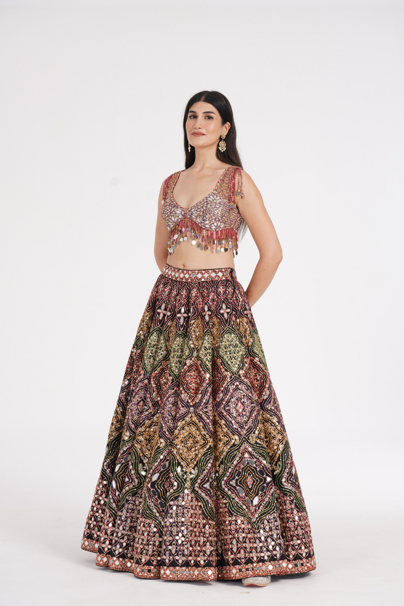 Matte black lehenga embellished using warm pastels