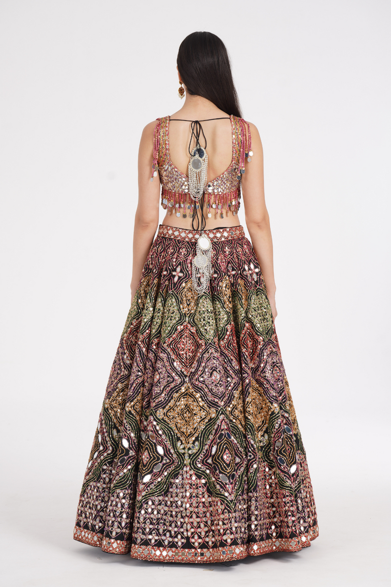 Matte black lehenga embellished using warm pastels